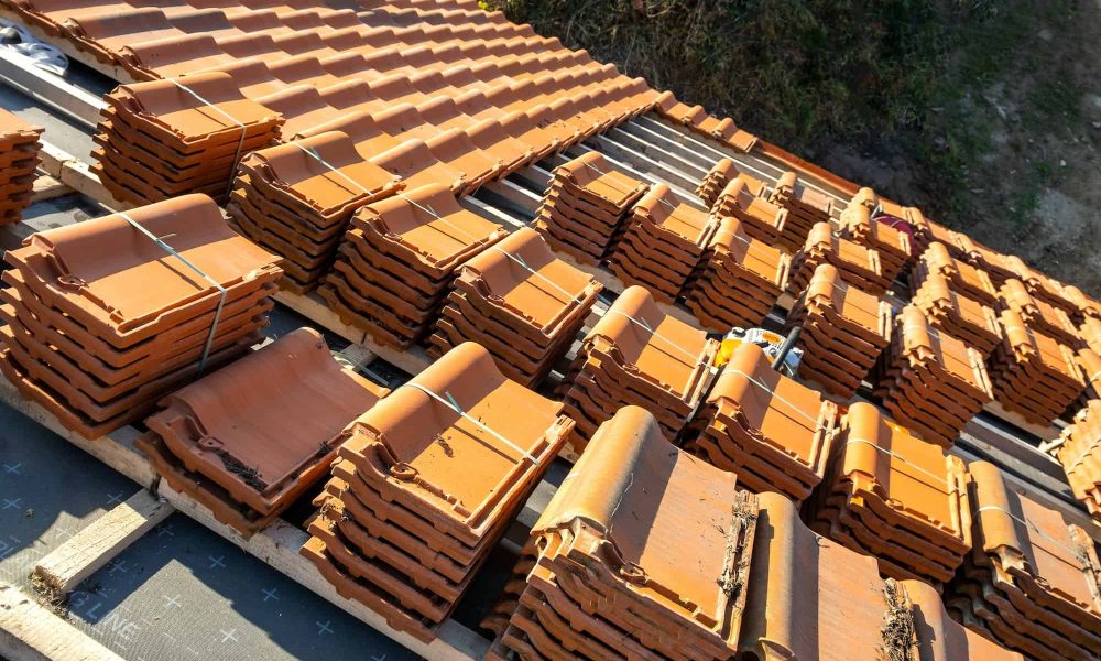 stacks-of-yellow-ceramic-roofing-tiles-for-covering-residential-building-roof-under-construction.jpg